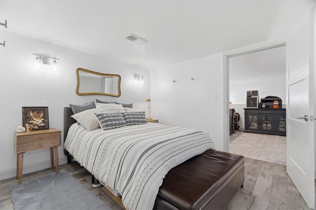 1 Pius Street, Unit B4 Pittsburgh, PA 15203 - Photo 29 of 41 a bedroom with a bed and a chandelier