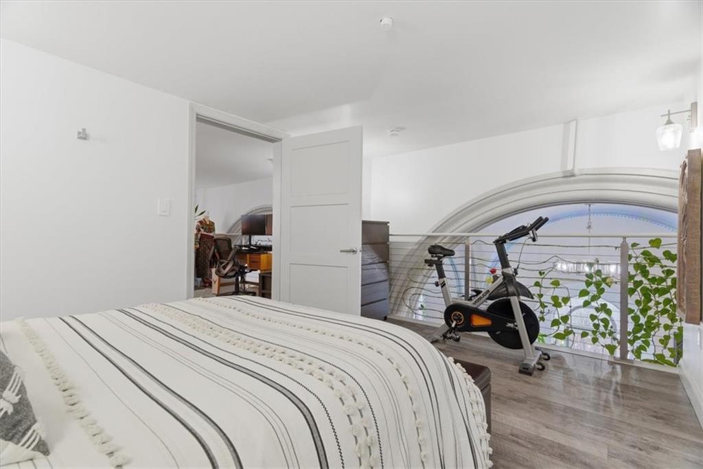 1 Pius Street, Unit B4 Pittsburgh, PA 15203 - Photo 30 of 41 a bedroom with a large bed and a chandelier