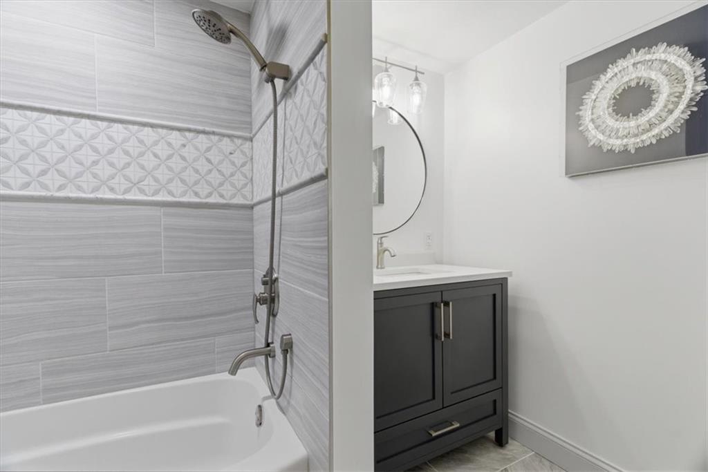 1 Pius Street, Unit B4 Pittsburgh, PA 15203 - Photo 31 of 41 a bathroom with a sink a mirror and a shower