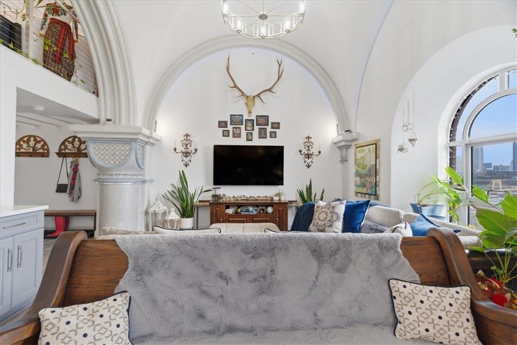 1 Pius Street, Unit B4 Pittsburgh, PA 15203 - Photo 7 of 41 a living room with furniture a flat screen tv and a floor to ceiling window