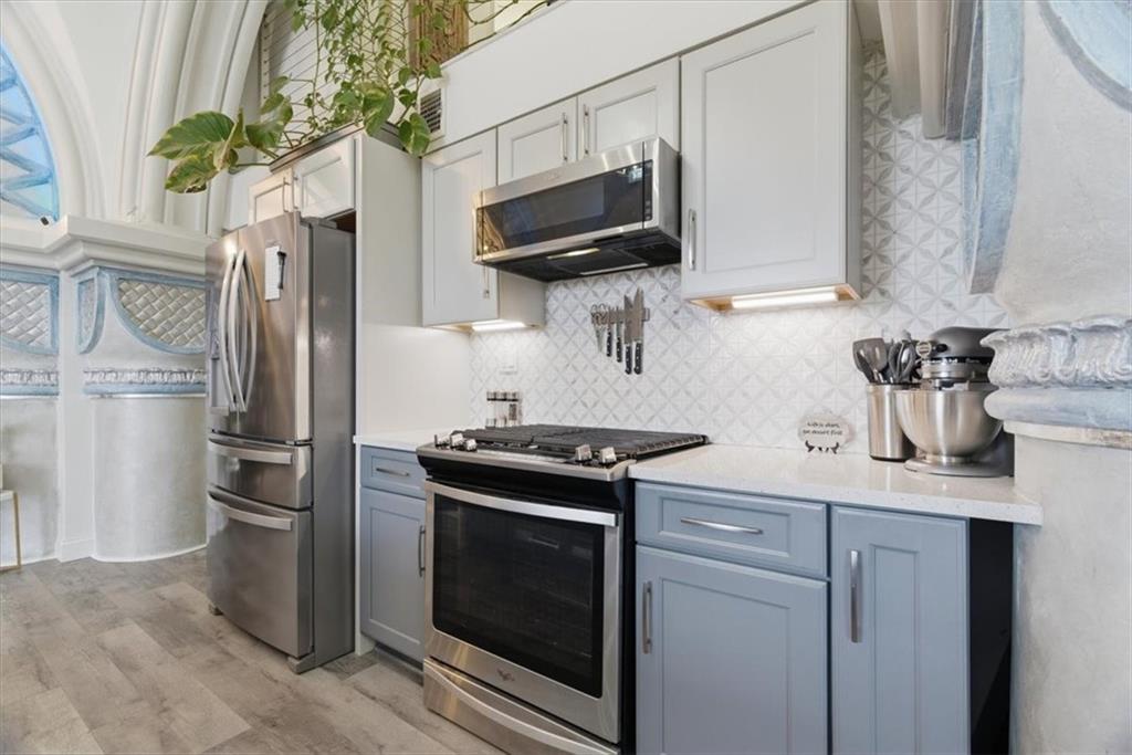 1 Pius Street, Unit B4 Pittsburgh, PA 15203 - Photo 9 of 41 a kitchen with stainless steel appliances a stove a microwave and a sink