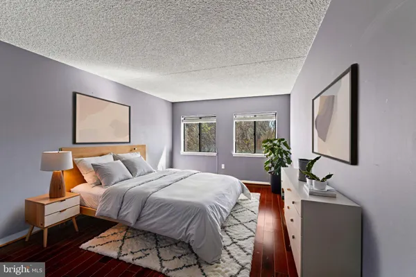 a bed room with a bed window and mirror