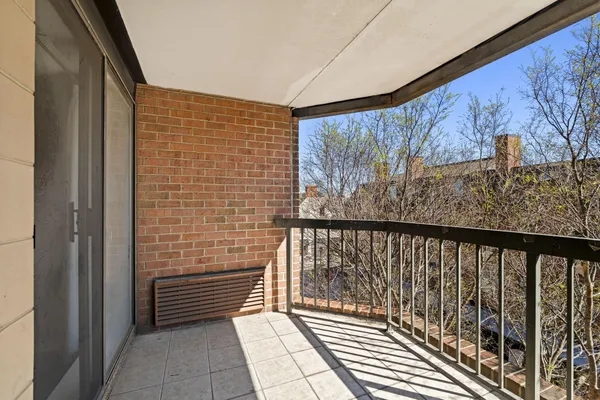 a view of a balcony with wooden floor