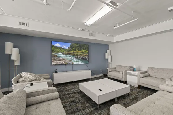 a living room with couches and a flat screen tv