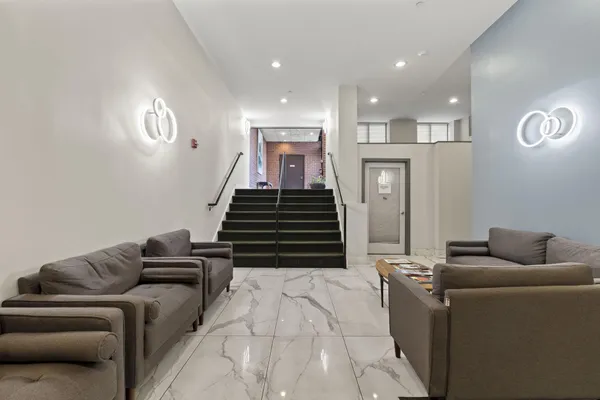 a living room with furniture and stairs