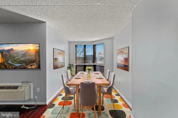 a view of a dining room with furniture wooden floor and window