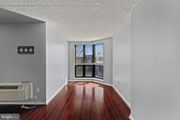 a view of a room with wooden floor and window