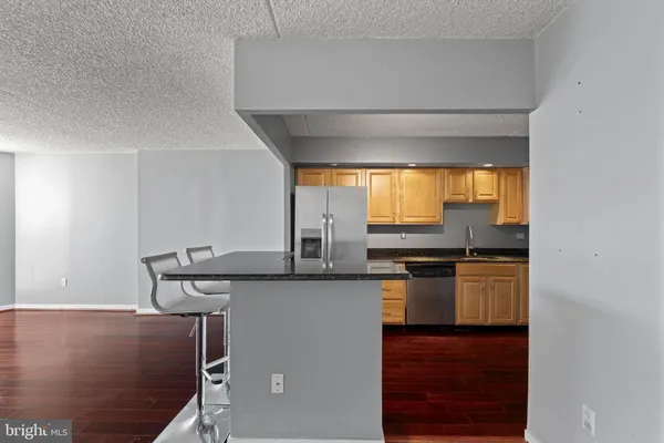 a kitchen with stainless steel appliances granite countertop a sink and a stove
