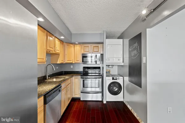a kitchen with stainless steel appliances granite countertop a stove and a refrigerator