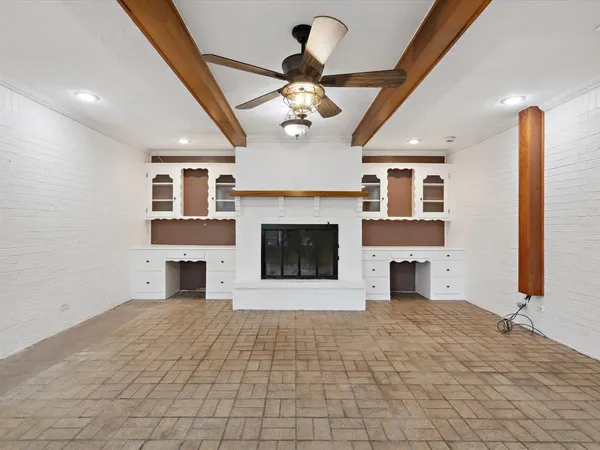 a view of an empty room with a fireplace