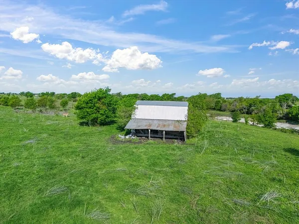 a view of a field with an ocean