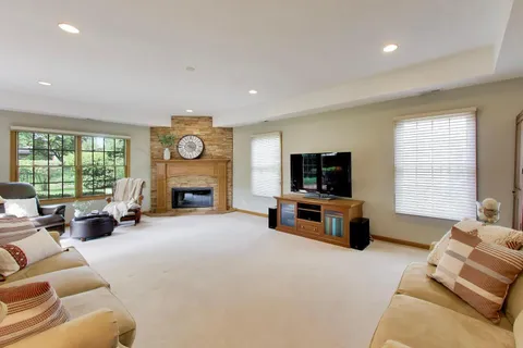 a living room with furniture and a fireplace