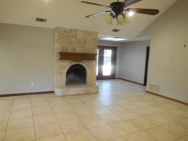 a view of an empty room with a fireplace