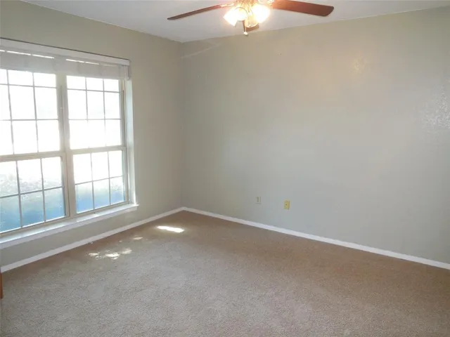 an empty room with a empty space and windows