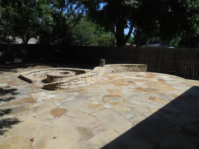 a backyard of a house with table and chairs