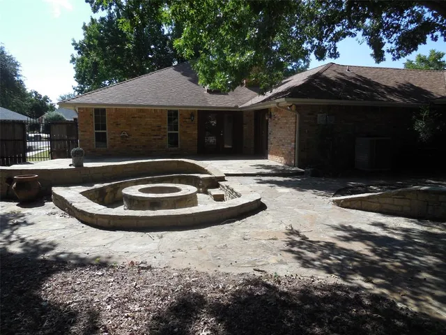 a view of house with yard and swimming pool