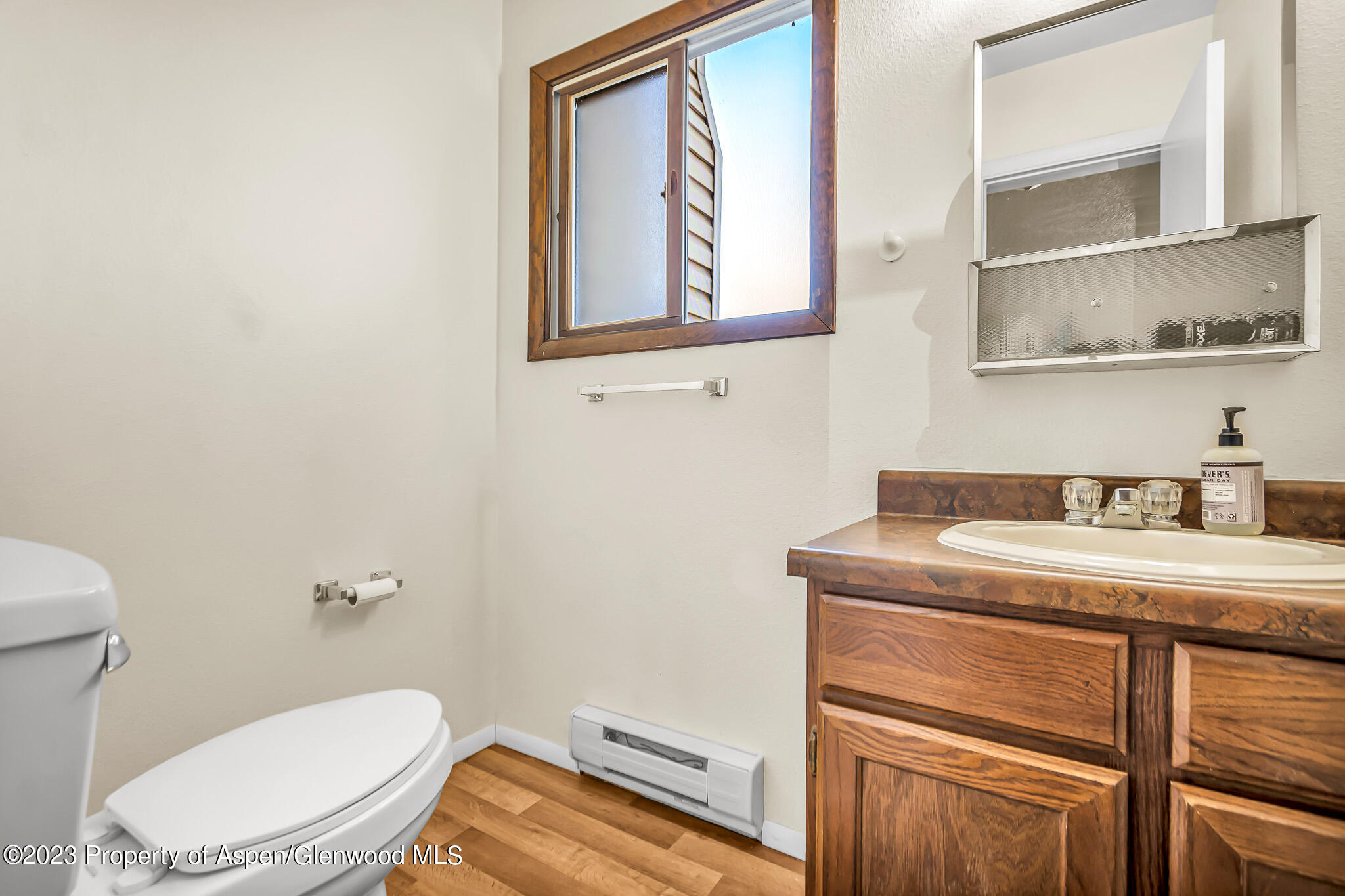 1002 Wamsley Way Rifle, CO 81650 - Photo 8 of 14 a bathroom with a toilet a sink and mirror