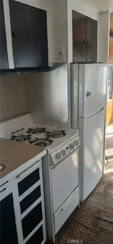 a stove top oven sitting inside of a kitchen