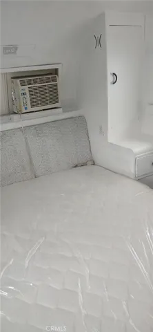a bedroom with a bed and a shower