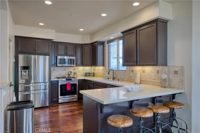 a dining room with furniture a window and wooden floor