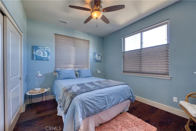 a bathroom with a granite countertop sink a toilet a mirror and shower