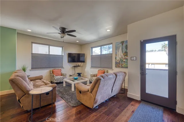 a living room with furniture ceiling fan and a window
