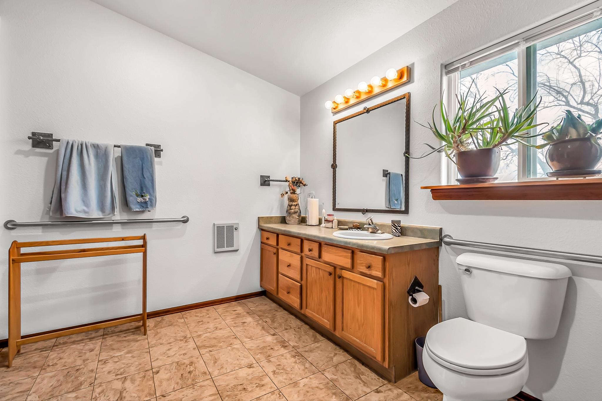 2075 I Road Fruita, CO 81521 - Photo 35 of 42 a bathroom with a granite countertop toilet sink and mirror