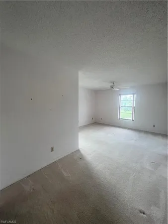 an empty room with a empty space and windows