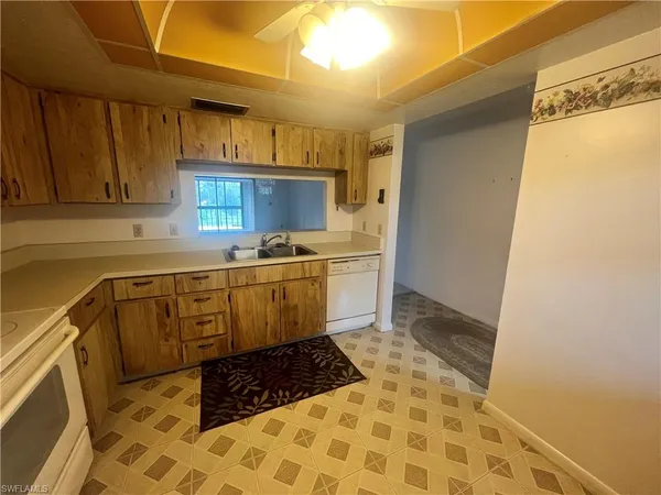 a kitchen with sink cabinets and window