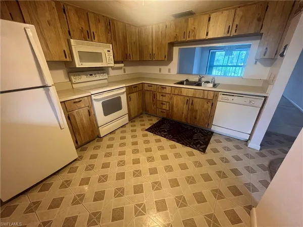 a kitchen with a stove a refrigerator and a sink