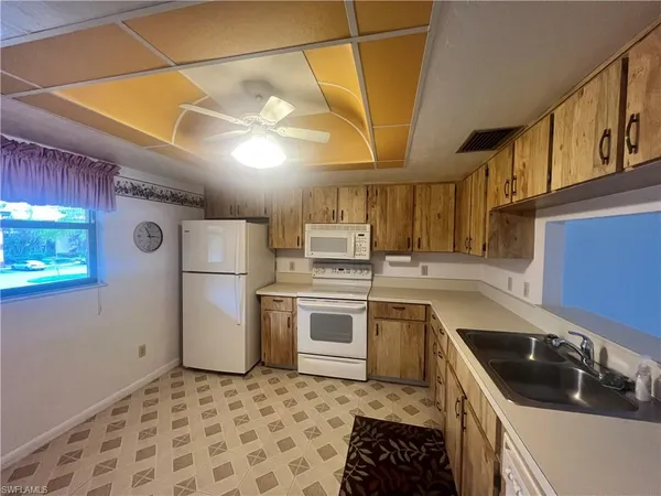 a kitchen with a sink appliances and cabinets