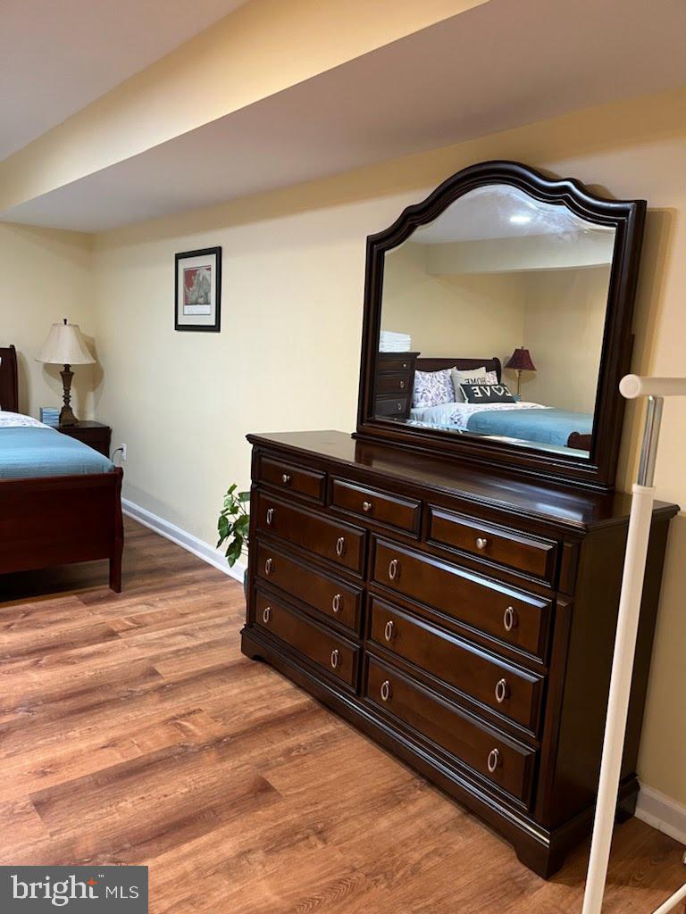 7288 Flaxpool Court Hanover, MD 21076 - Photo 12 of 23 a bedroom with a bed and a mirror on dresser