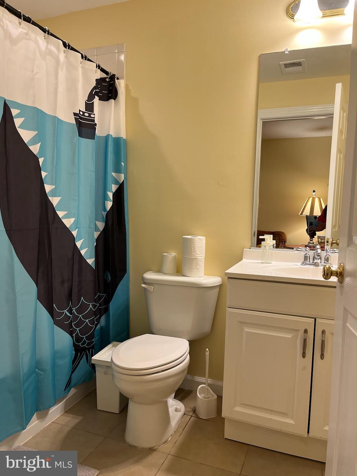 7288 Flaxpool Court Hanover, MD 21076 - Photo 15 of 23 a bathroom with a granite countertop toilet sink and mirror