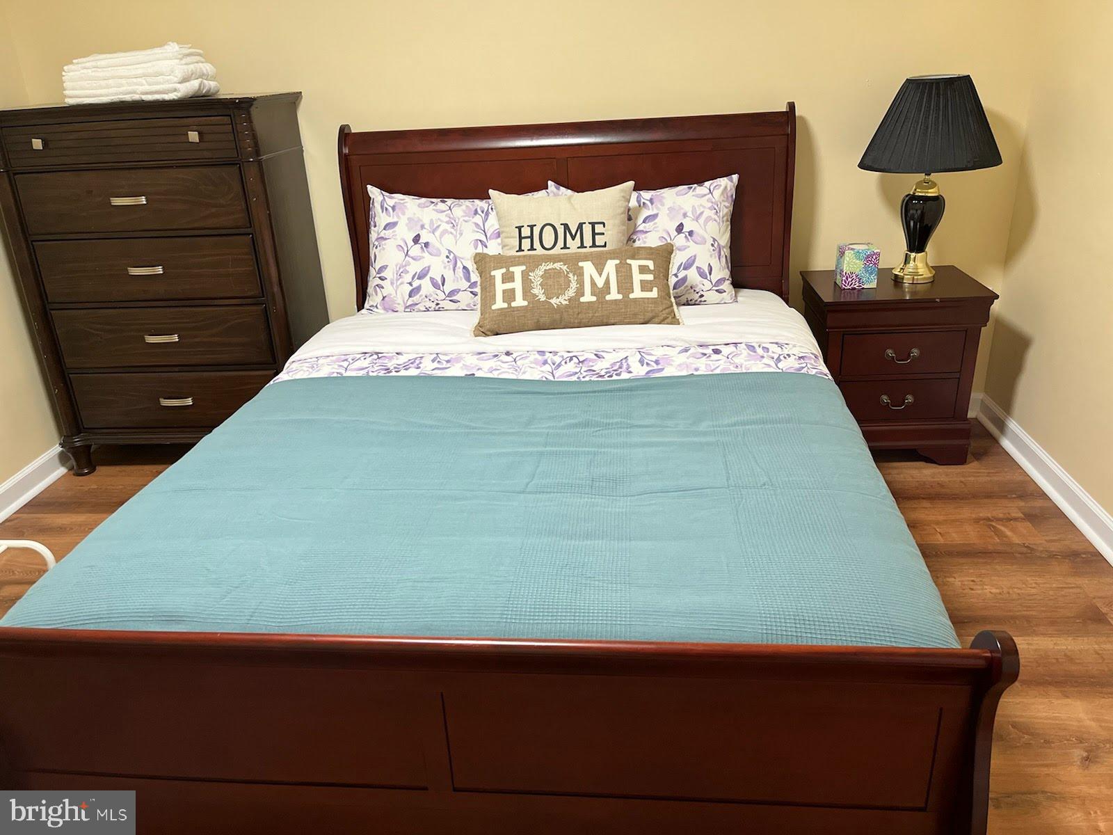 7288 Flaxpool Court Hanover, MD 21076 - Photo 10 of 23 a bedroom with a bed and a night stand