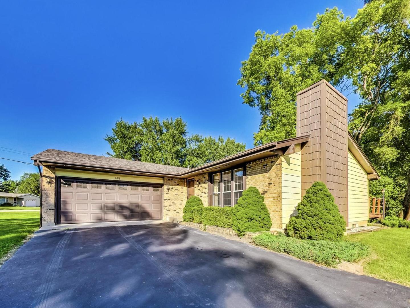 a front view of a house with a yard and a garage