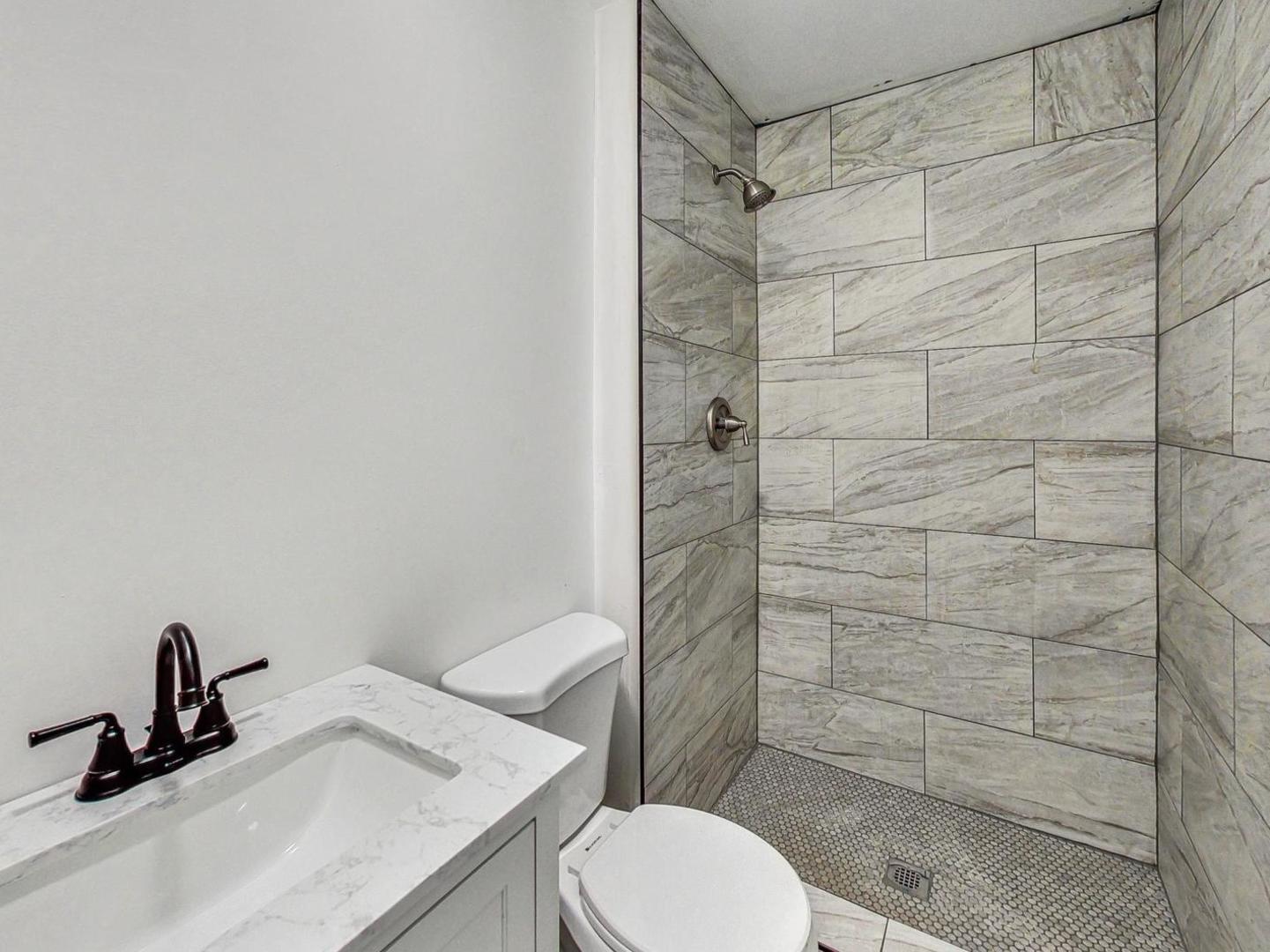 4618 William Street Johnsburg, IL 60051 - Photo 16 of 40 a bathroom with a sink toilet and shower