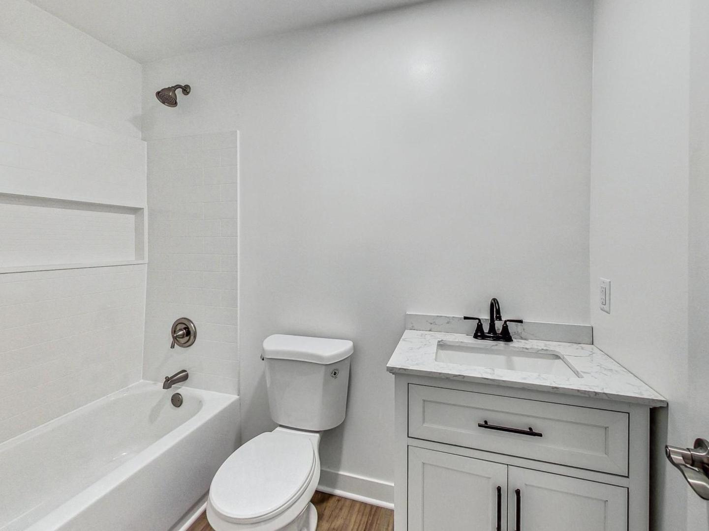 4618 William Street Johnsburg, IL 60051 - Photo 22 of 40 a white toilet sitting next to a bathroom sink