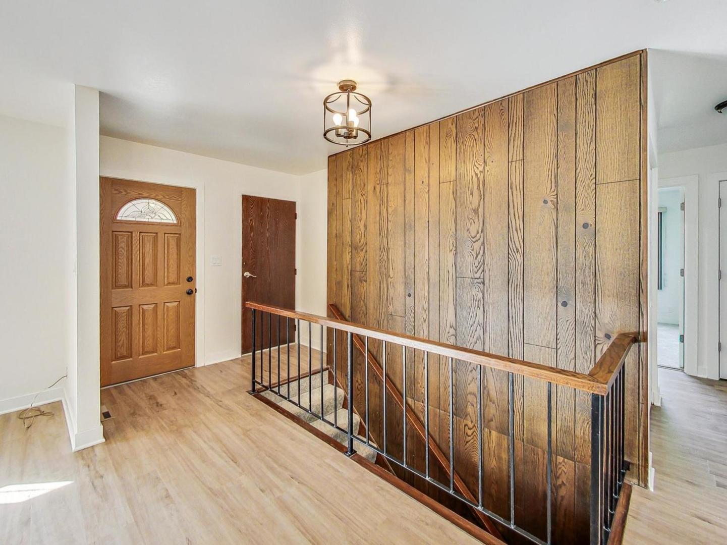 4618 William Street Johnsburg, IL 60051 - Photo 4 of 40 a view of a hallway with wooden floor and stairs