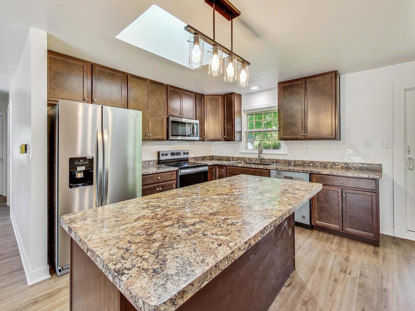 4618 William Street Johnsburg, IL 60051 - Photo 6 of 40 a kitchen with stainless steel appliances granite countertop a sink stove and refrigerator
