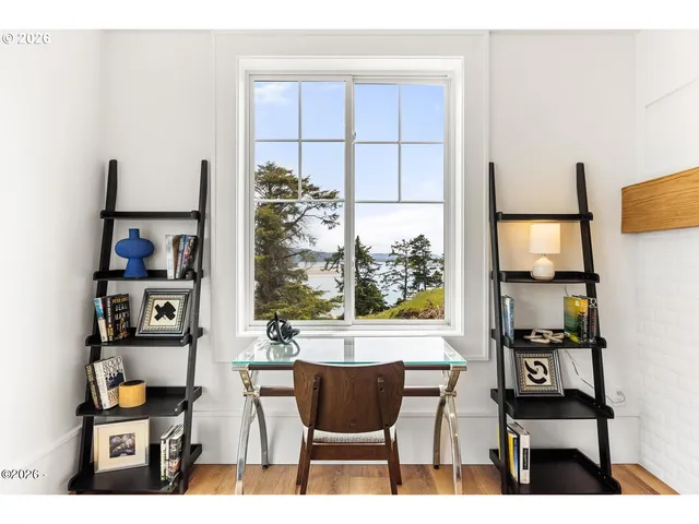 a view of a dining room with furniture and a window