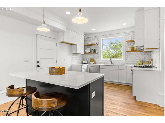 a kitchen with a sink cabinets and window