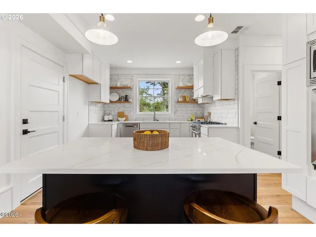 a kitchen with a sink cabinets and window
