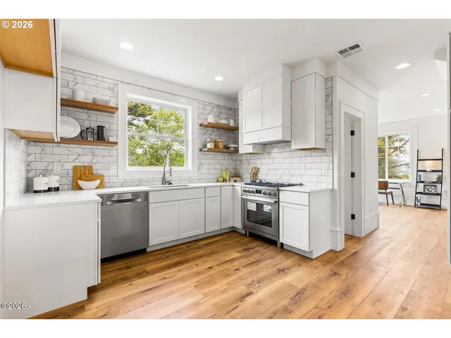 a kitchen with a white wooden cabinets and white appliances