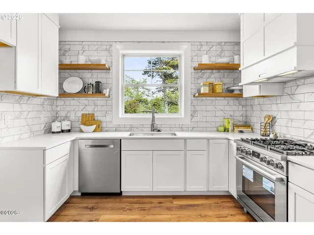 a kitchen with a sink stove and cabinets