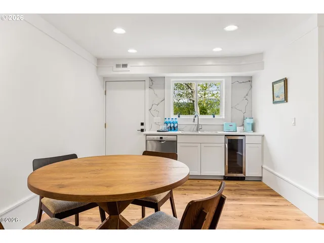 a kitchen with a table chairs and a refrigerator