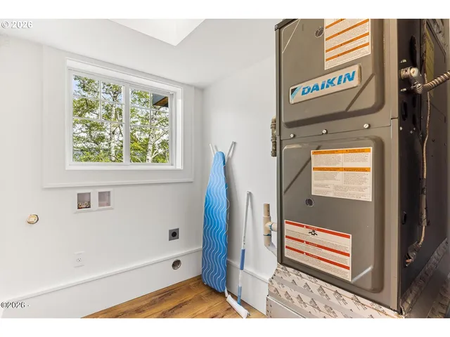 a view of a bedroom with furniture and window
