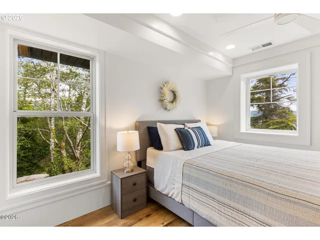 a bedroom with a bed and a large window