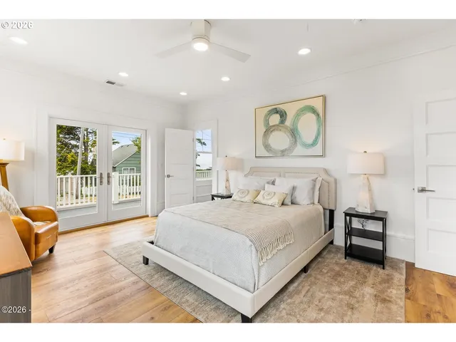 a spacious bedroom with a bed a couch and a window