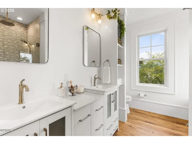 a bathroom with a double vanity sink mirror and