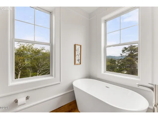a bathroom with a bathtub and window